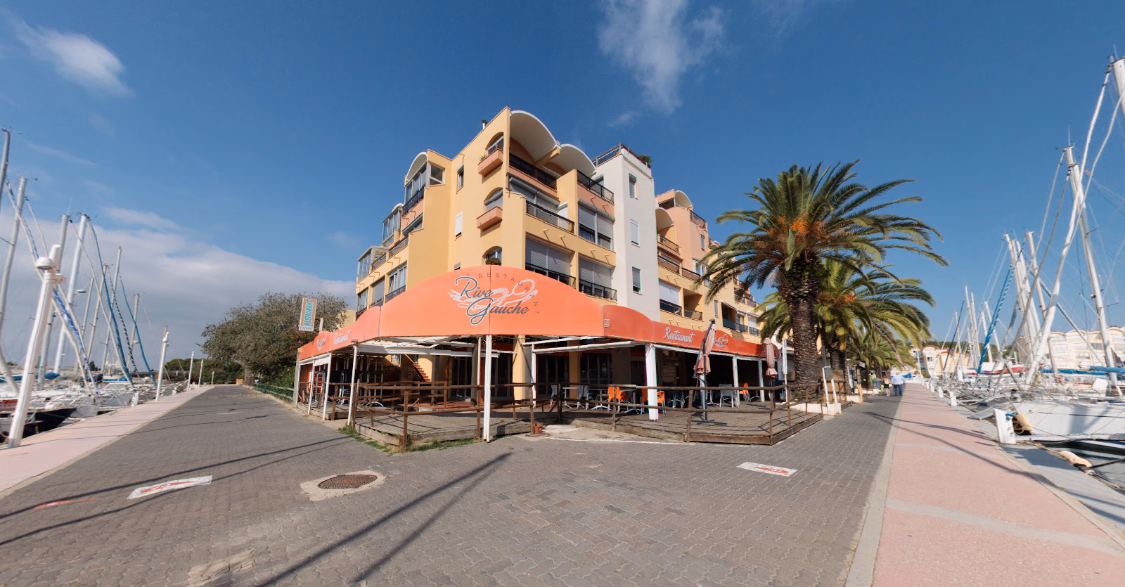 Murs commerciaux de restaurant occupés sur le port de Gruissan, avec terrasse et quais de plaisance